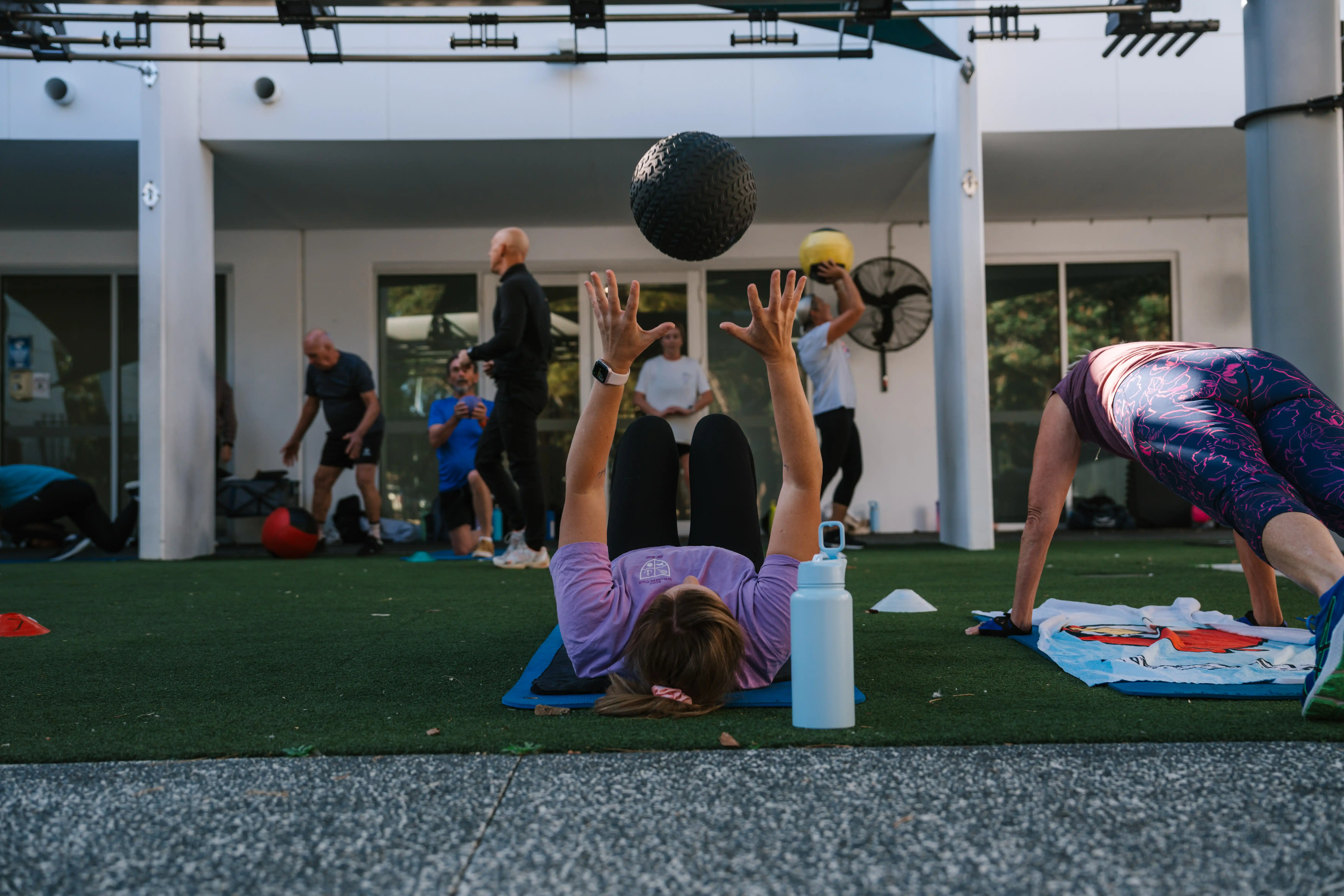 People doing the swot box gym class outside