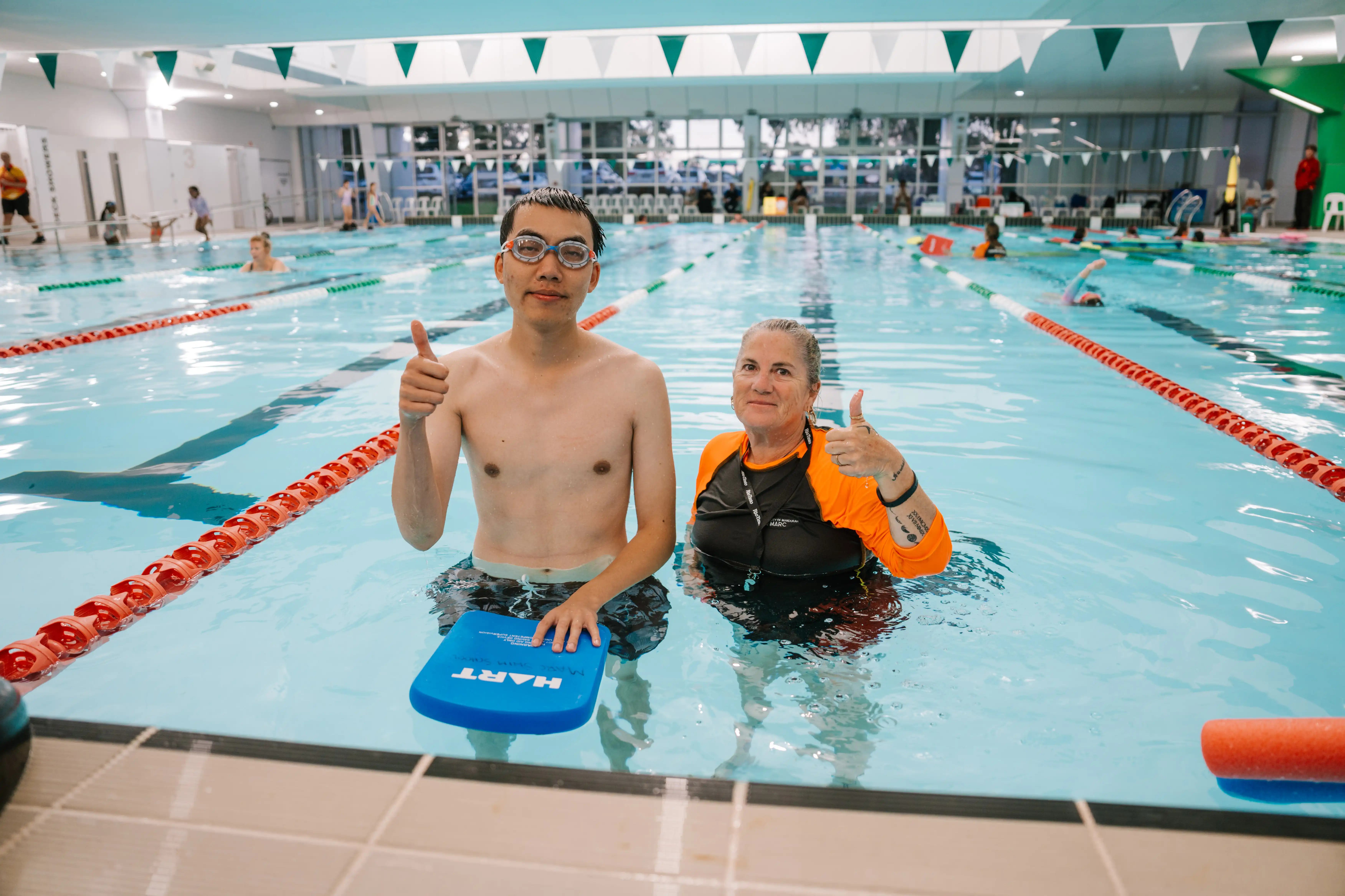 Adult and swim teacher in swim lesson.