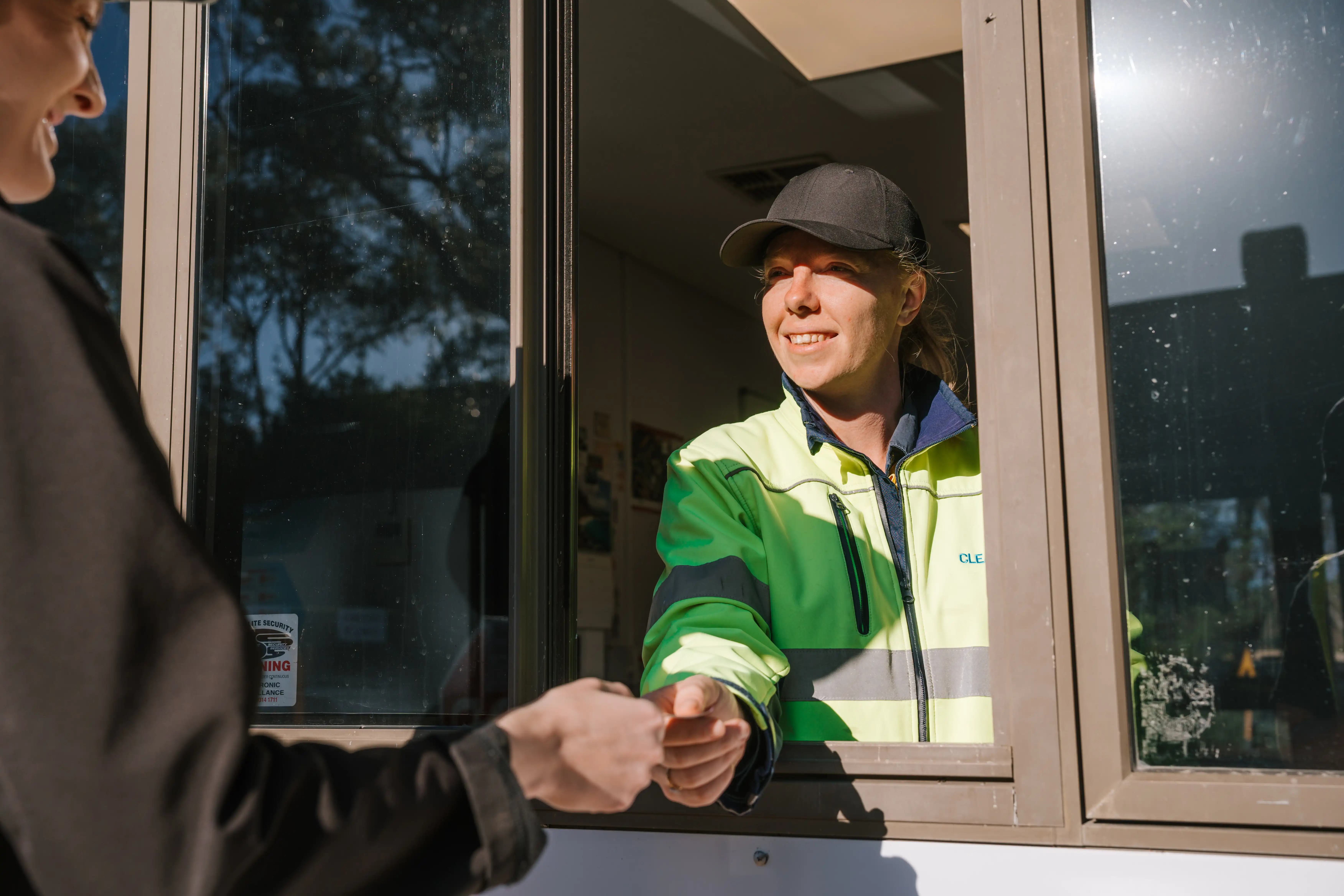 A waste management officer accepting a tip pass at the service window
