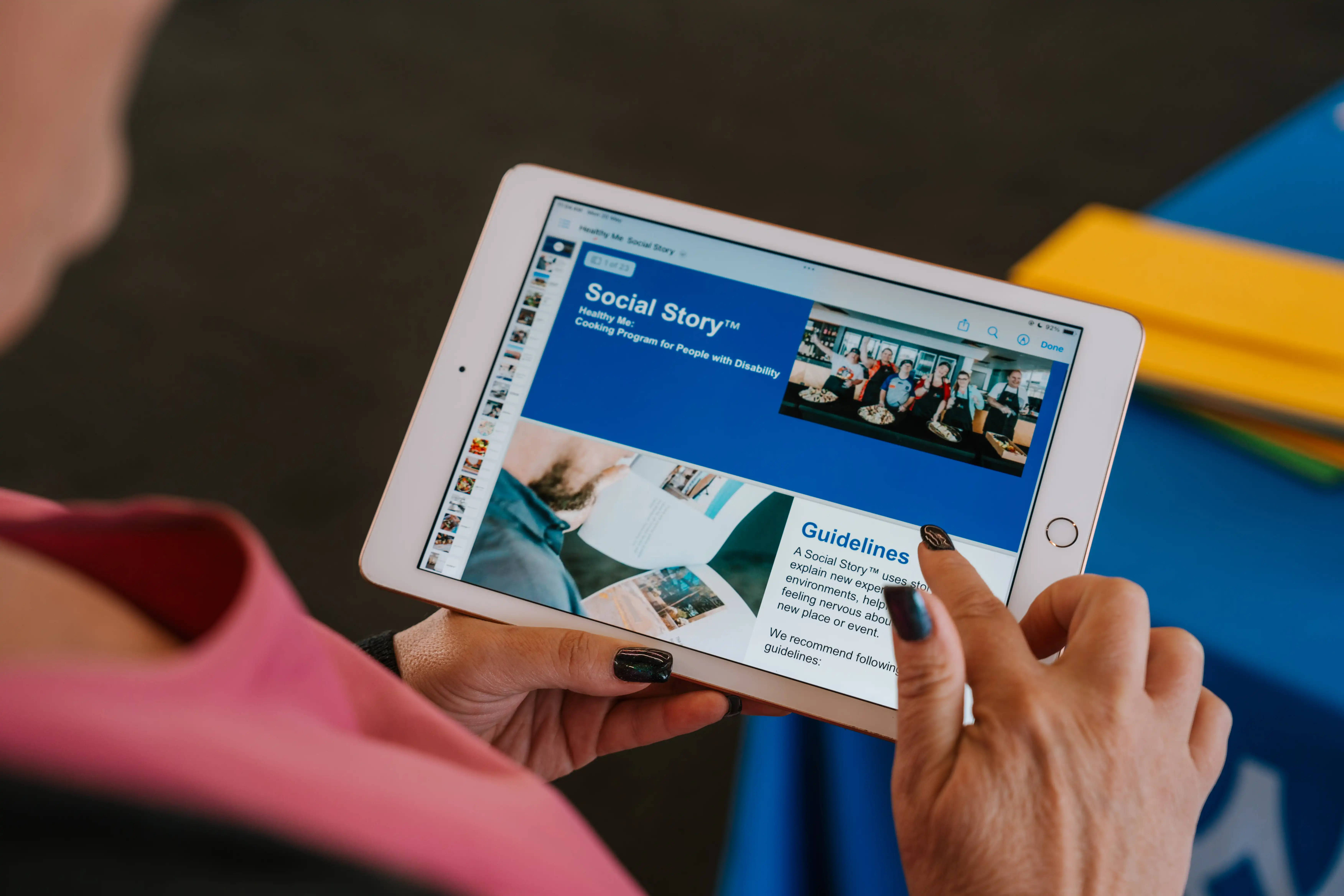 Person using a tablet to view a social story resource designed to help people with disability prepare for activities.